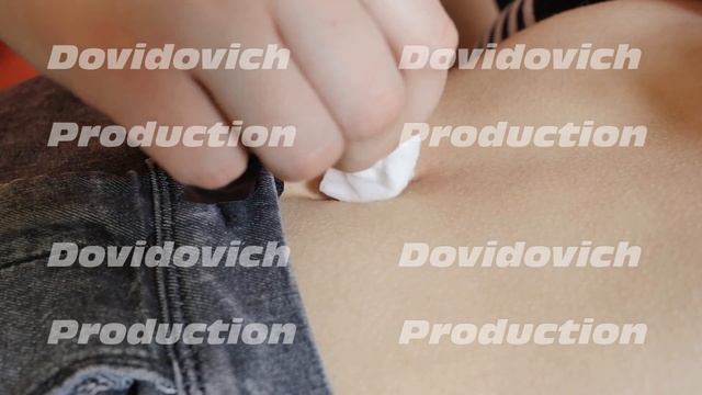 The first piercing. Female piercing. Treatment of the first piercing with a brush.