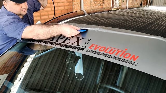 Клею правильно наклейку, на лобовое стекло Мицубиси Каризма.