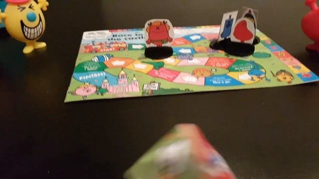 Mr. Mischief Mr. Greedy Mr. Grumpy And Little Miss Helpful Playing A Board Game